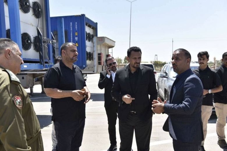 مسؤولون يتفقدون شاحنات مبردة.